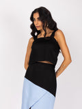 Elegant black and blue midi skirt and blouse set with a modern, asymmetrical design.