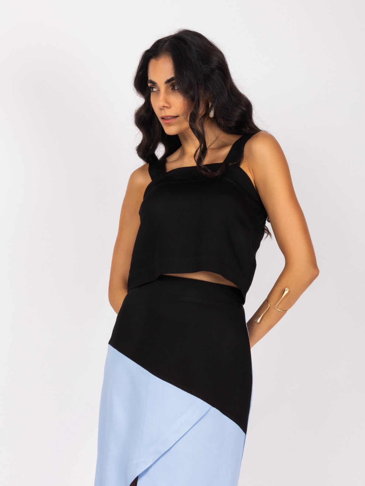 Elegant black and blue midi skirt and blouse set with a modern, asymmetrical design.